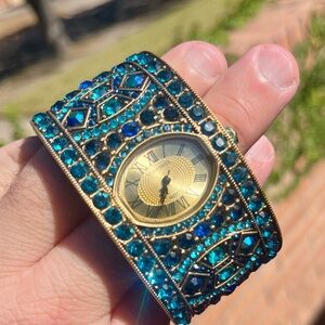 Heidi Daus bangle watch in tones of blue, turquoise, and aquamarine. HSN